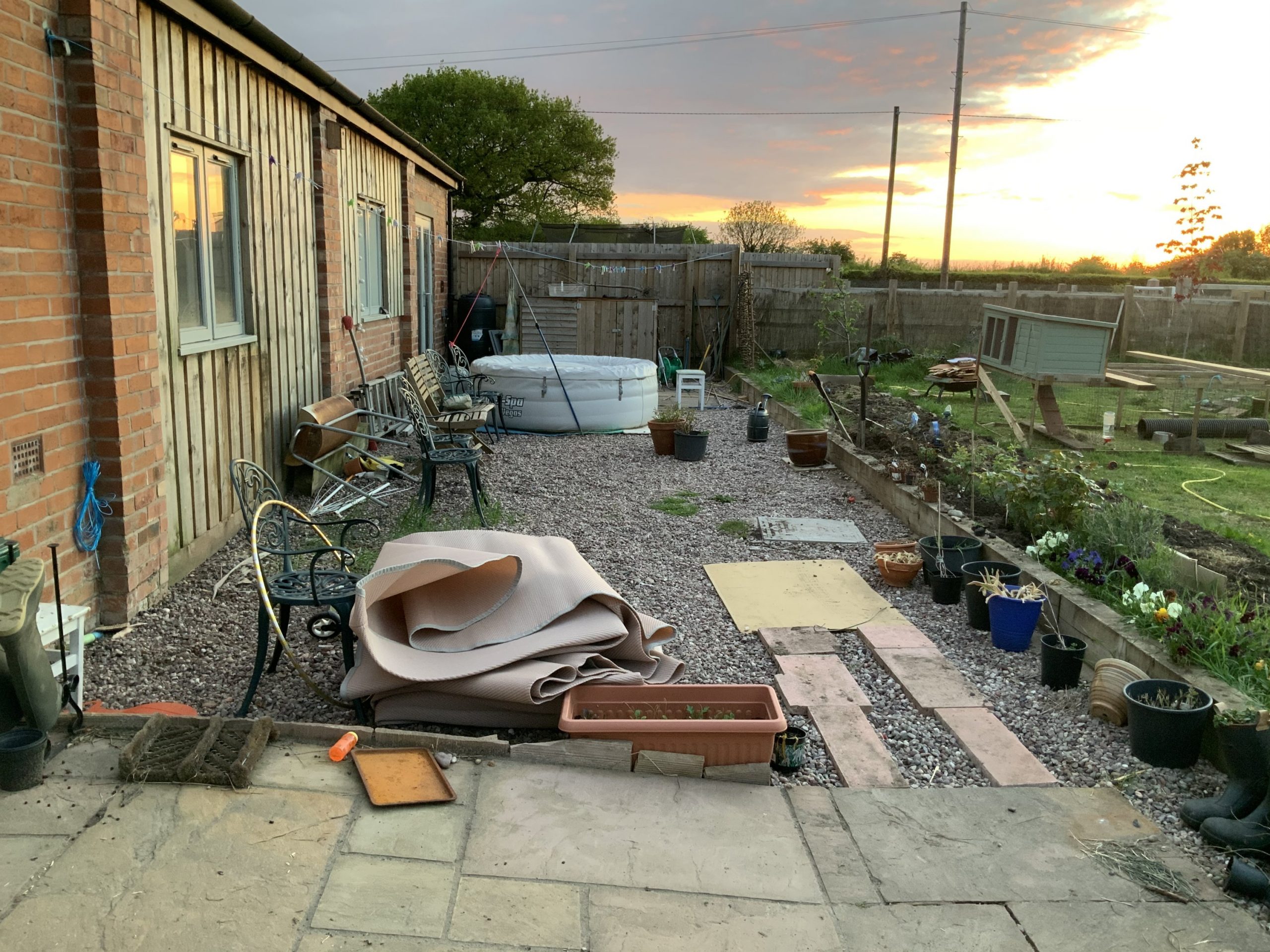 The area in the garden as it looks now. Gravel and filled with chairs, camping bits, ladders, old plant pots. Debris, basically!