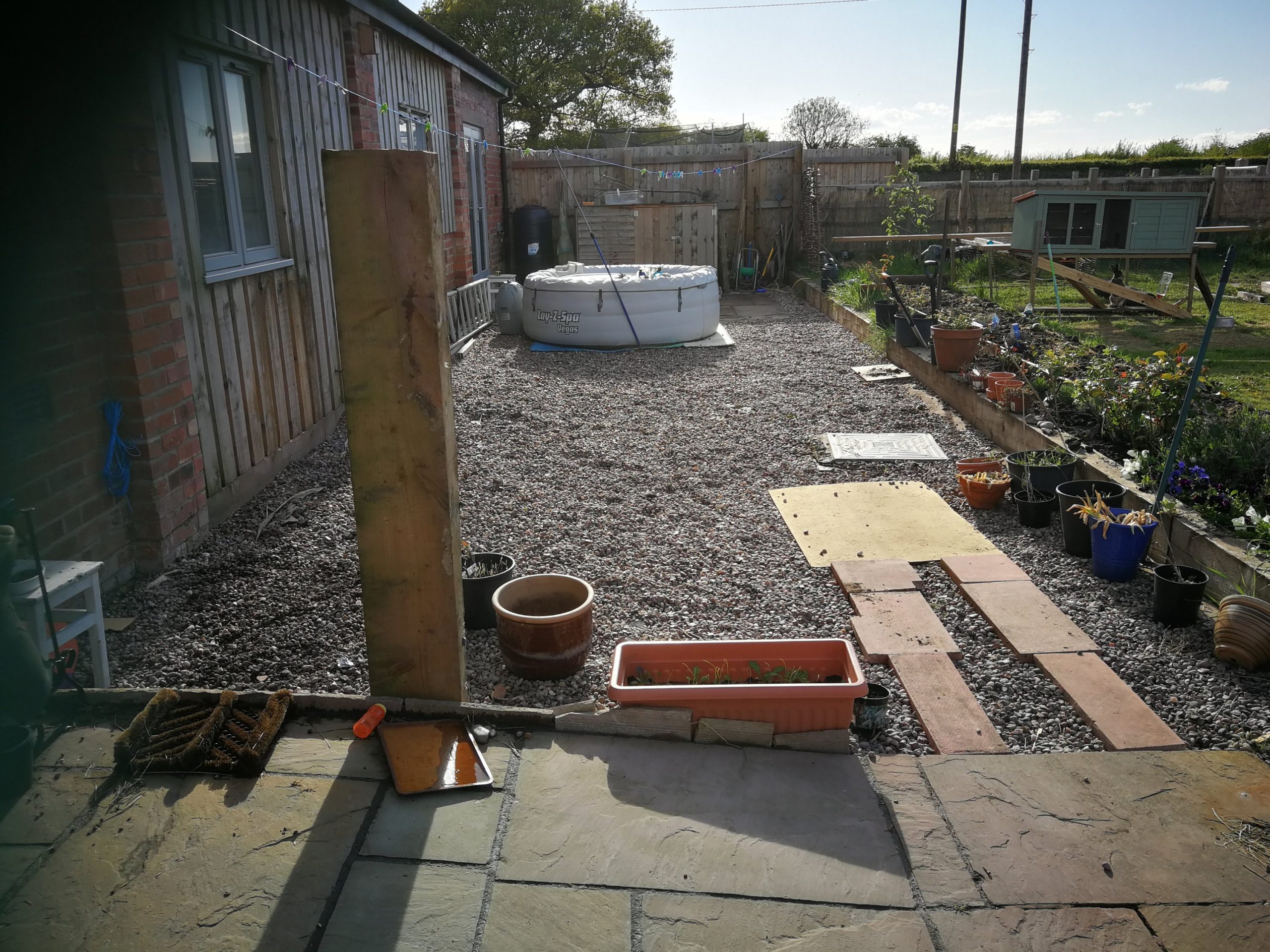 Picture of the area that will become the sensory garden. All gravel and up against the house. A hot tub sits in at the far end but will be moved before we start creating the garden.